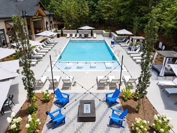 Modern pool with outdoor gas grilling station and fire pit